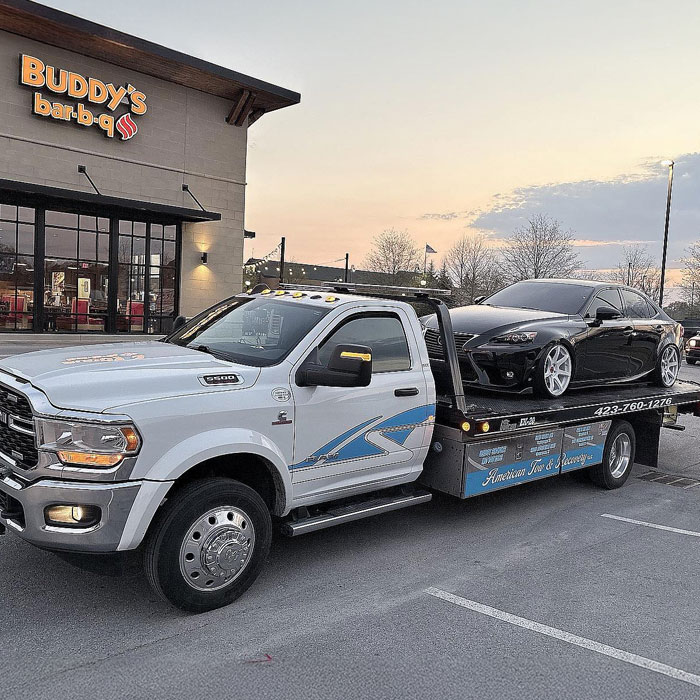 Rotator Service American Tow and Recovery Chattanooga flatbed tow truck towing a car