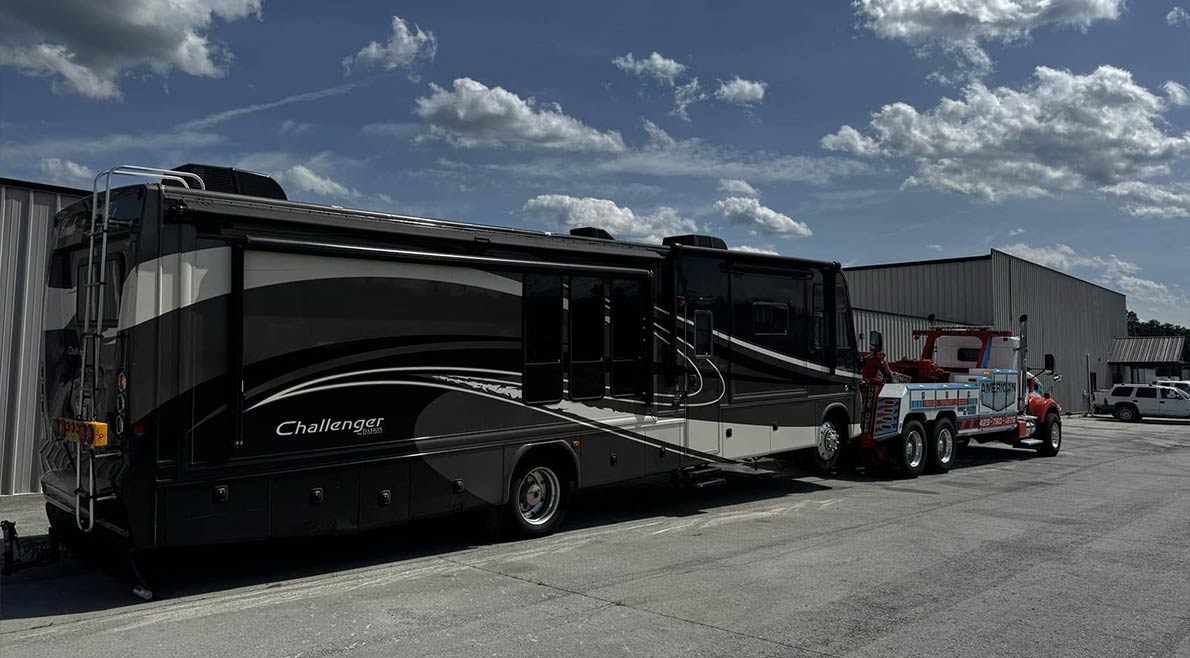 diesel-pusher-rv-towing-service American Tow Company towing a large diesel pusher RV using specialized towing equipment.