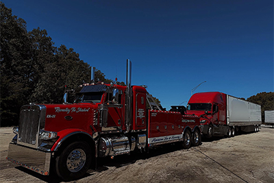 American Tow & Recovery towing a fully loaded tractor trailer